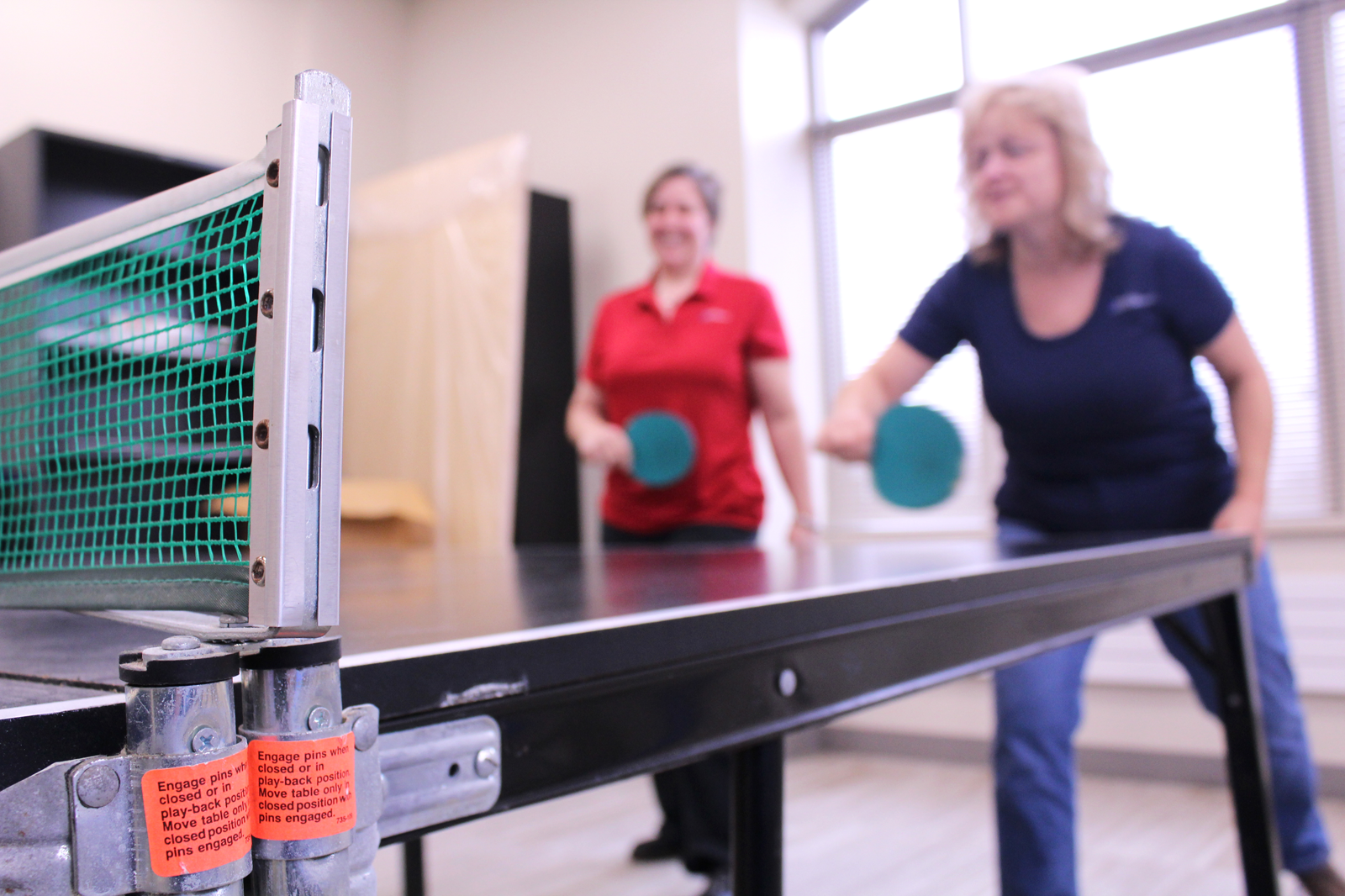 Ring & DuChateau staff enjoy a break playing ping pong